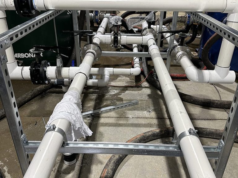 White PVC manifold piping in a commercial mechanical room