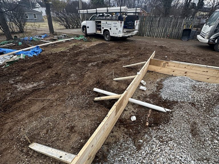 Excavated footer with a drain line on a construction site