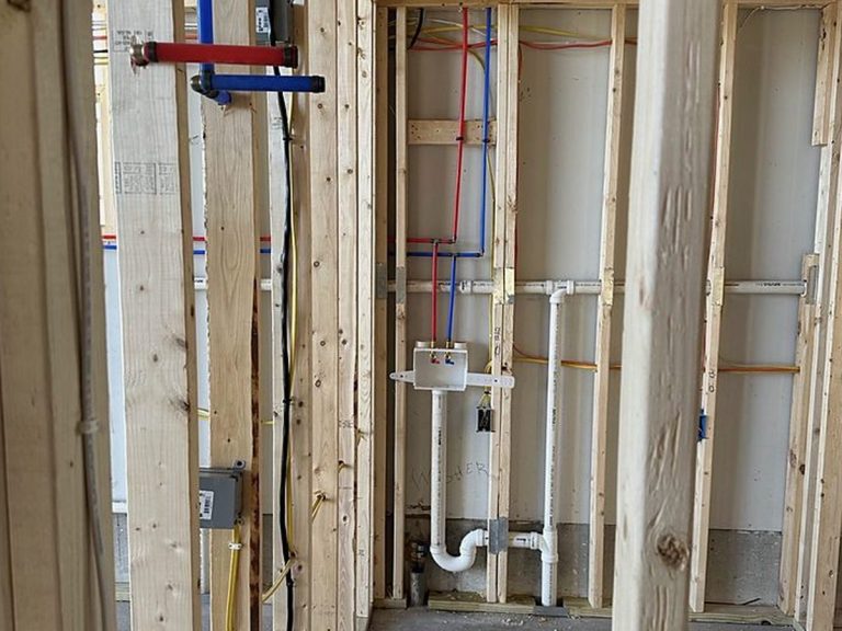 PEX and drain lines roughed in along framed walls
