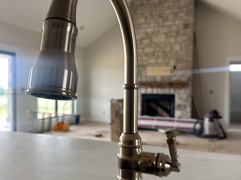 Brushed gold kitchen faucet on a white counter