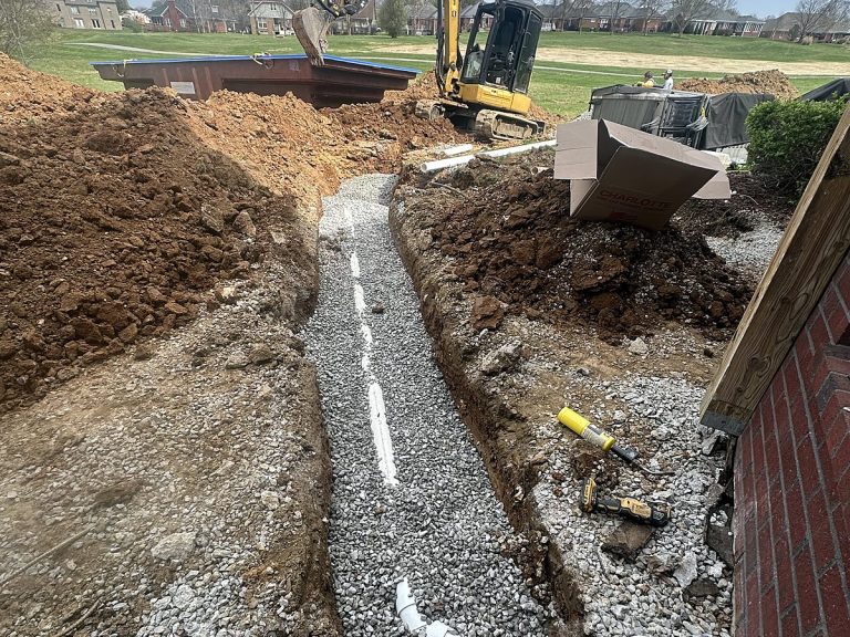 Long trench with a sewer line and an excavator