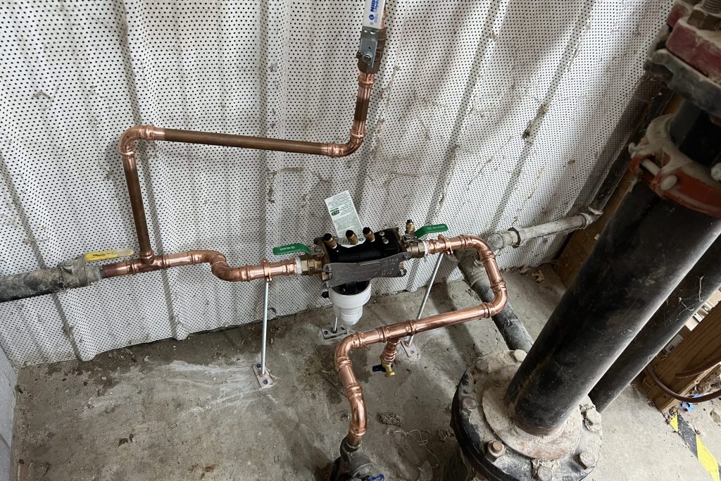 Copper feed and backflow assembly on a commercial line