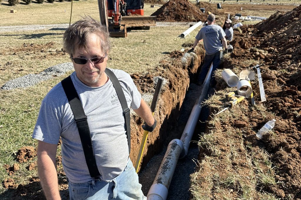 Allied Plumbing crew working a line in a trench