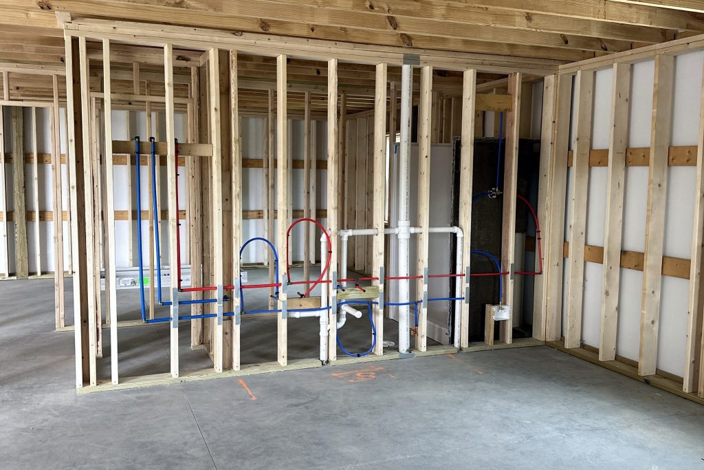 Plumbing rough-in through the framing of a new house