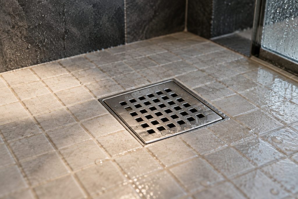 Square tile shower drain with water pooling